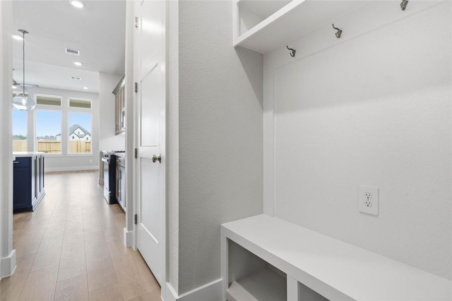 The ultimate in organization and cleanliness—a dedicated mudroom designed to manage daily life with ease. This highly desirable space serves as the perfect "drop zone" between the outdoors and your main living areas, helping to keep your home tidy and clutter-free.