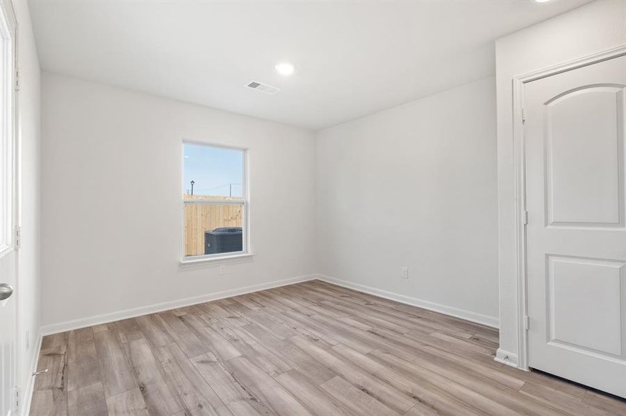 Unfurnished room with light hardwood / wood-style flooring