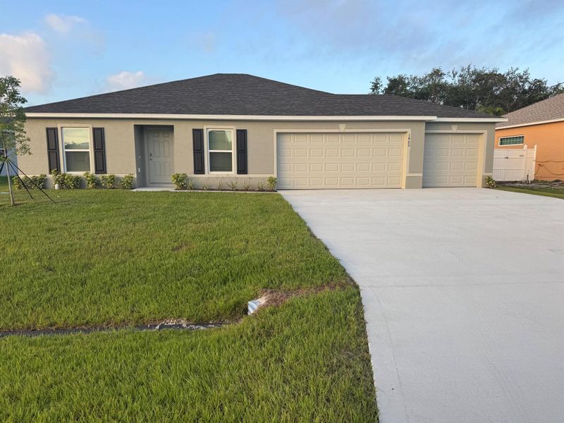 Front exterior of a new home in Port St Lucie, Port St. Lucie, FL, highlighting curb appeal (Image 1).