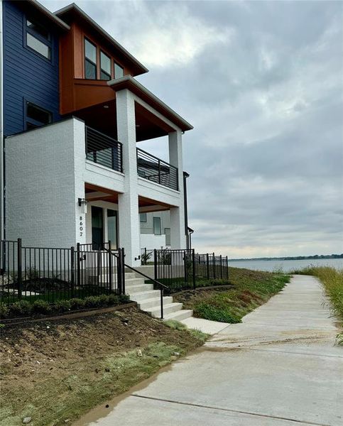 View of side of home with a water view