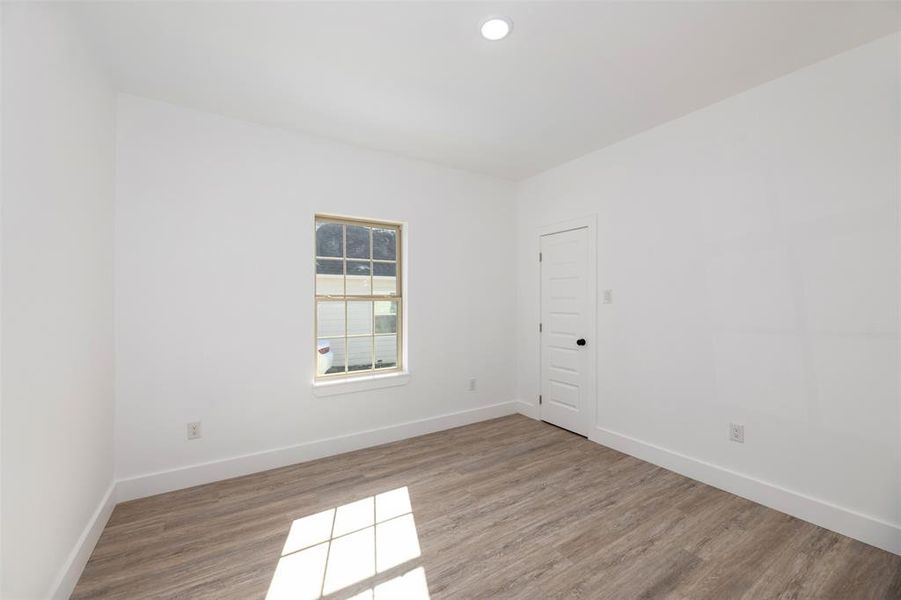 Unfurnished room featuring wood finished floors and recessed lighting Unfurnished room featuring wood finished floors and recessed lighting