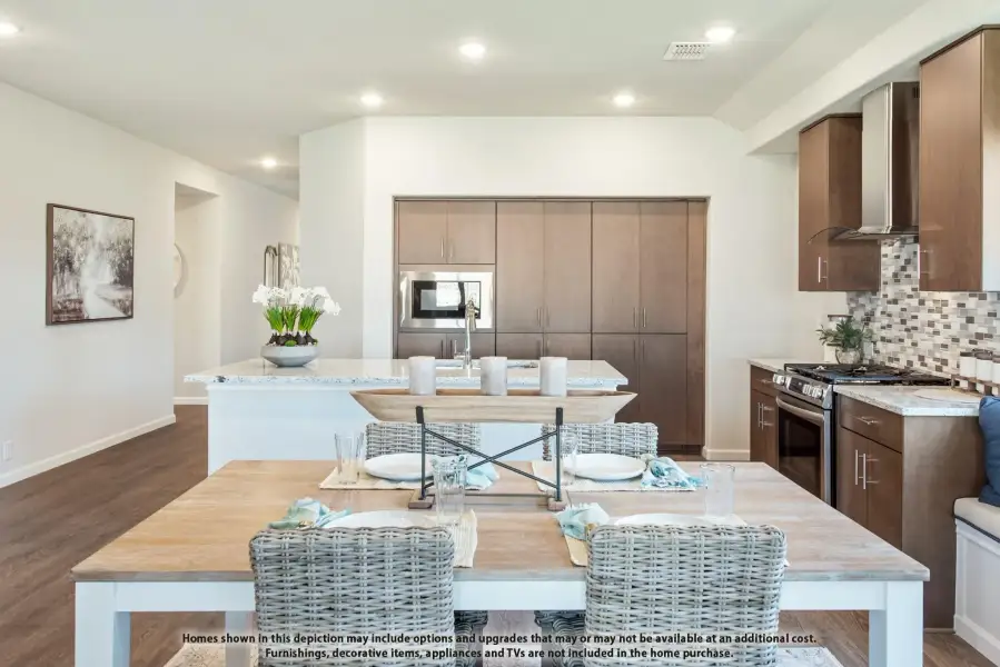 Open kitchen and dining area with dark wood cabinets, granite island, tile backsplash, and wood dining table with wicker chairs