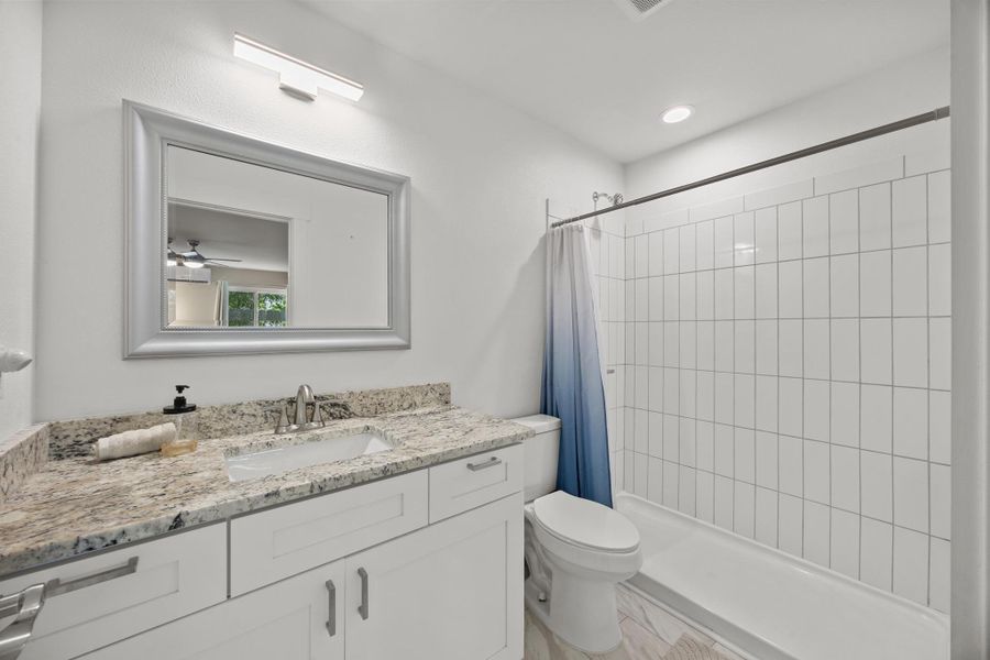 Full bathroom with tub/shower combo and beautiful granite counters,