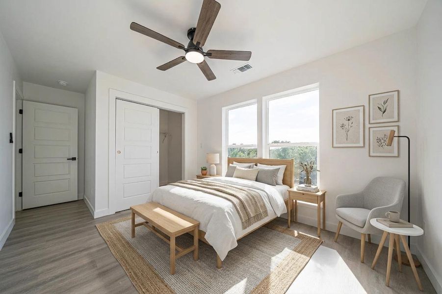 Sunlight streams through large windows into this modern bedroom featuring a spacious walk-in closet. Sunlight streams through large windows into this modern bedroom featuring a spacious walk-in closet.