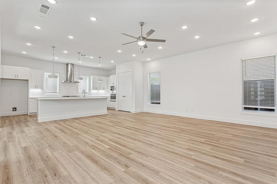 Unfurnished living room featuring light wood-style floors, recessed lighting, and ceiling fan