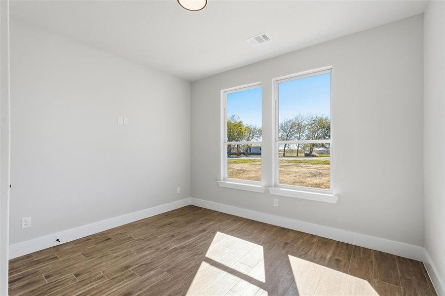 Empty room with baseboards and wood finished floors