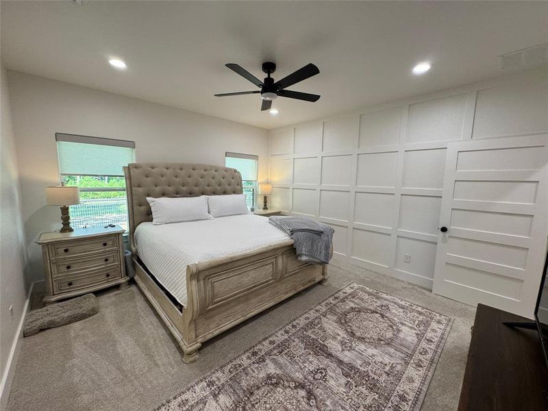 Master or Primary bedroom with a decorative wall, a ceiling fan, and recessed lighting Master or Primary bedroom with a decorative wall, a ceiling fan, and recessed lighting