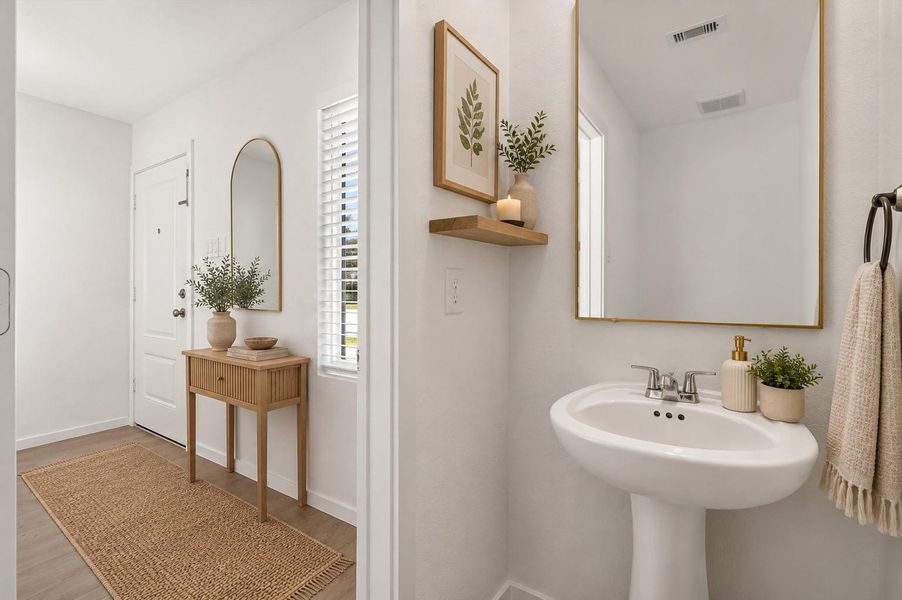 A conveniently located half bath adds functionality for family and guests.