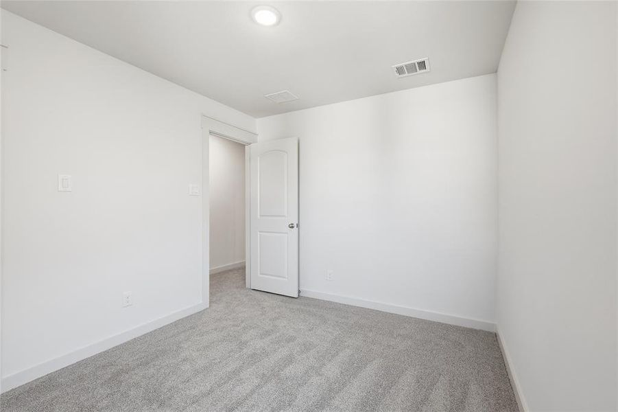 Empty room with carpet floors and baseboards Empty room with carpet floors and baseboards