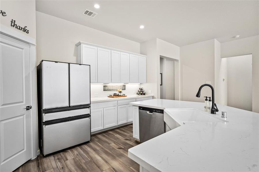 A view of your kitchen from the dining area.  Note the long countertop, perfect for serving buffet style meals to family and friends for gatherings and holidays.