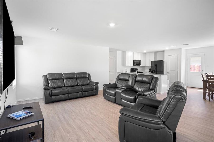 Living area featuring light wood-style flooring and baseboards Living area featuring light wood-style flooring and baseboards