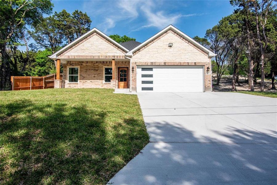 View of front of home featuring a garage and a front yard