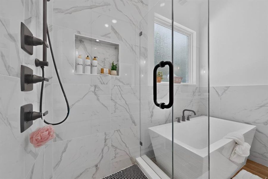 Contemporary bathroom featuring a frameless glass shower enclosure, a built-in shower niche with recessed lighting, and a square soaking tub