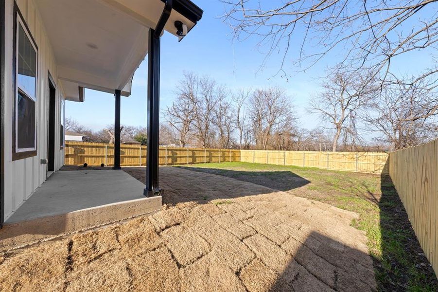 Fenced backyard featuring a patio