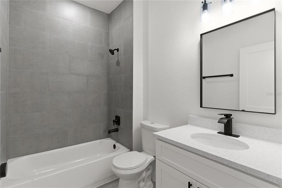 Guest Bathroom with tiled tub surround