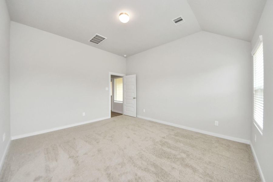 Come and unwind after a long day in this magnificent primary suite! This spacious room features plush carpet, warm paint, high ceilings and large windows with privacy blinds. Sample photo of completed home with similar floor plan. Actual colors and selections may vary. Come and unwind after a long day in this magnificent primary suite! This spacious room features plush carpet, warm paint, high ceilings and large windows with privacy blinds. Sample photo of completed home with similar floor plan. Actual colors and selections may vary.