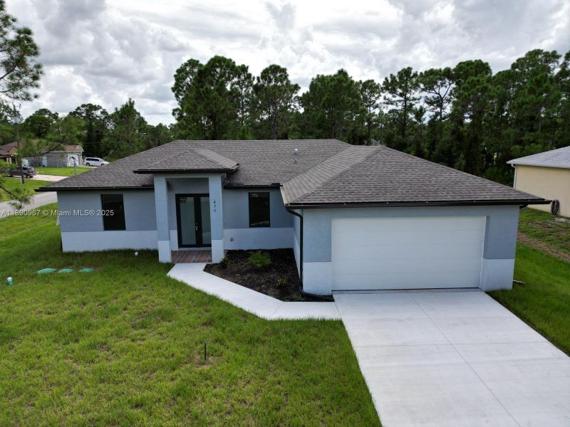 Front exterior of a new home in , Lehigh Acres, FL, highlighting curb appeal (Image 1). Front exterior of a new home in , Lehigh Acres, FL, highlighting curb appeal (Image 1).