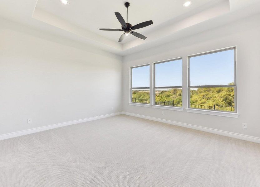 Unfurnished room with a raised ceiling, light colored carpet, baseboards, and recessed lighting Unfurnished room with a raised ceiling, light colored carpet, baseboards, and recessed lighting
