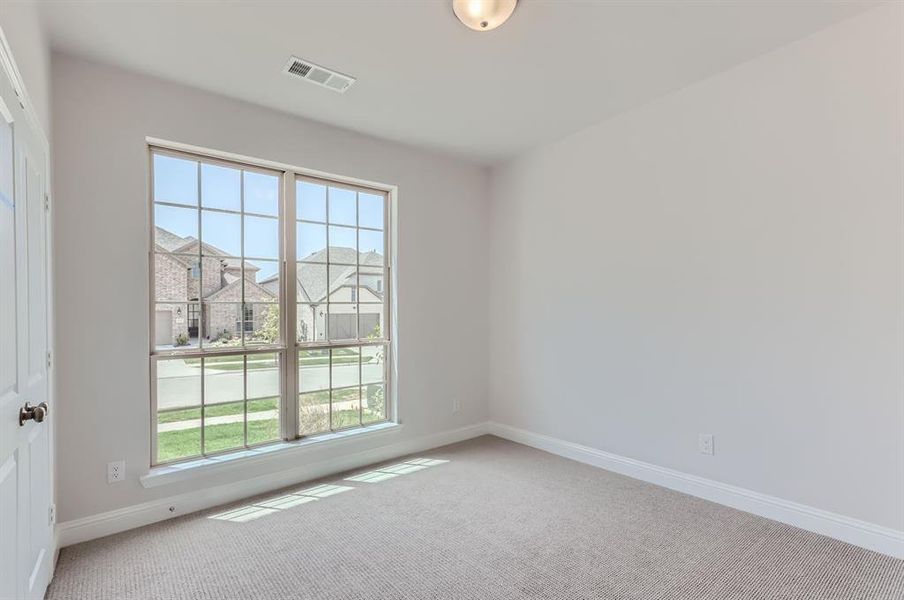 Empty room with carpet flooring and a wealth of natural light