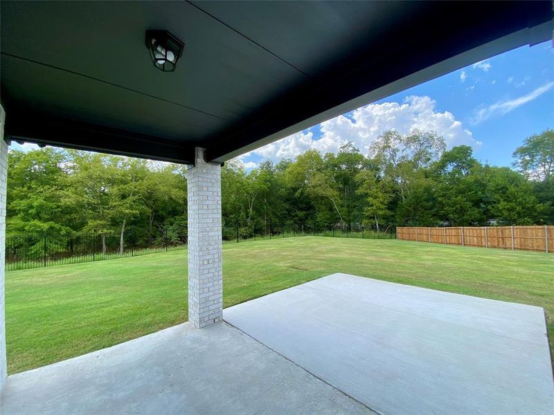 Covered patio overlooks huge yard and has extra concrete for future extended covered patio. Covered patio overlooks huge yard and has extra concrete for future extended covered patio.