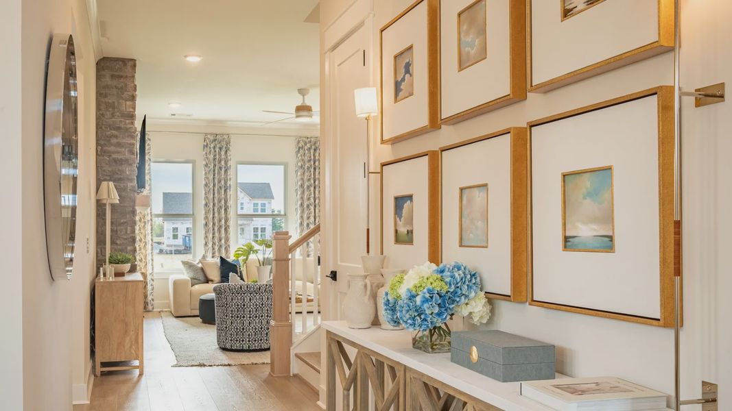 Expertly designed entry leading to great room after passing bedroom and formal living room