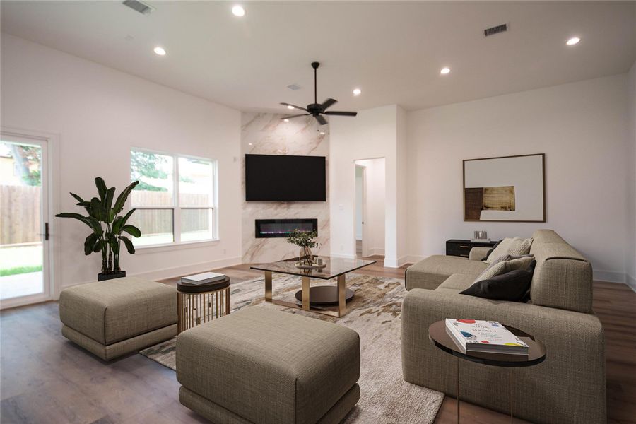 This floor plan features an expansive living room with a contemporary fireplace, creating a cohesive space. The living room has been virtually staged to help you envision yourself in this living area. This floor plan features an expansive living room with a contemporary fireplace, creating a cohesive space. The living room has been virtually staged to help you envision yourself in this living area.