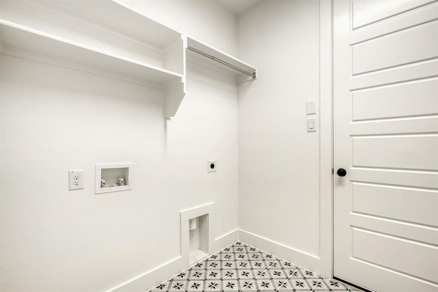 Laundry area featuring electric dryer hookup, hookup for a washing machine, and light floors
