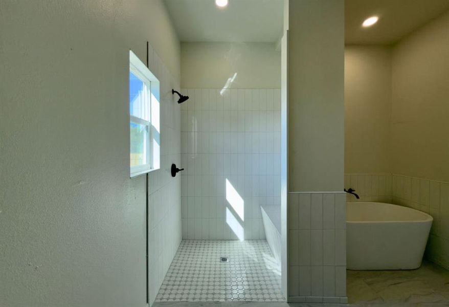 Full bath featuring a soaking tub and a walk in shower Full bath featuring a soaking tub and a walk in shower