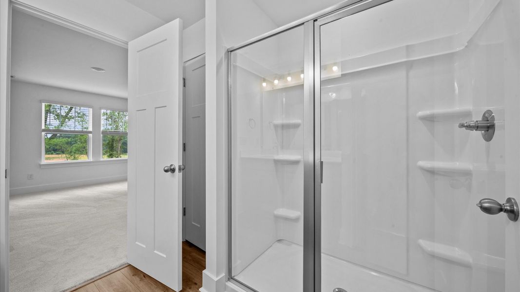 Walk-in shower in primary bathroom in two story townhome at Ransdell Pointe by DRB Homes in Spartanburg, SC
