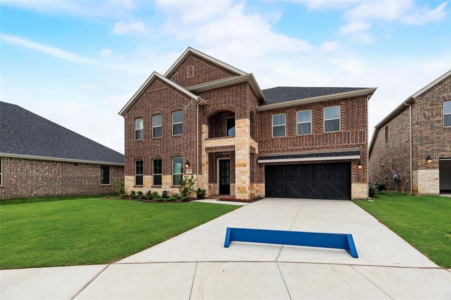 Front exterior of a new home in Valencia On The Lake, Little Elm, TX, highlighting curb appeal (Image 18).