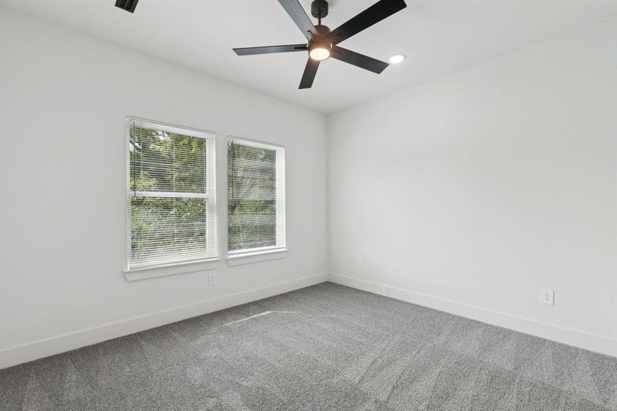 Spare room with carpet flooring, ceiling fan, and recessed lighting