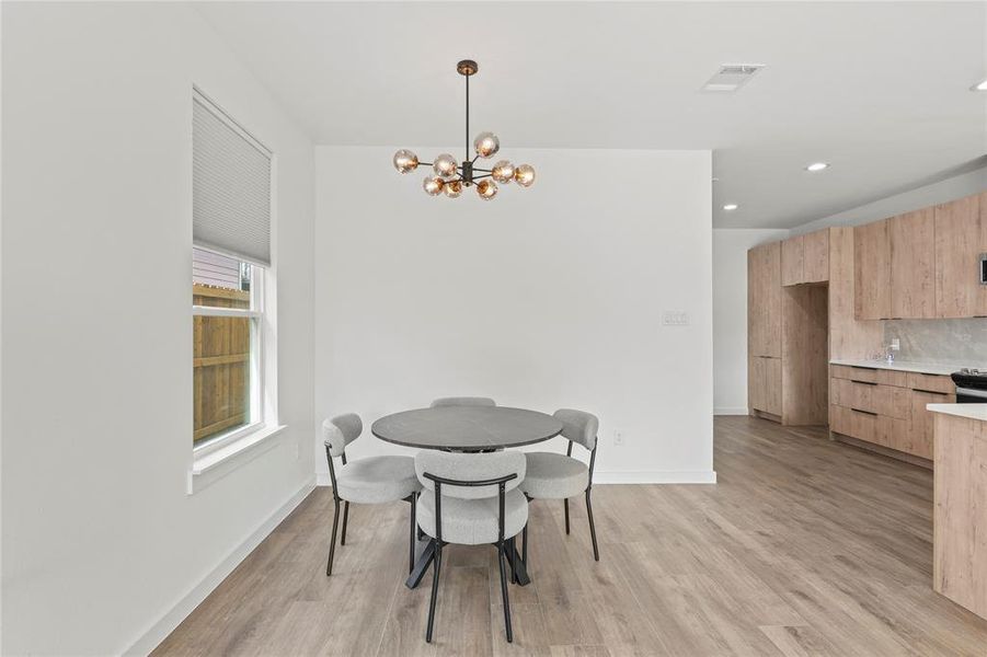 Dining room featuring a notable chandelier and light hardwood / wood-style floors