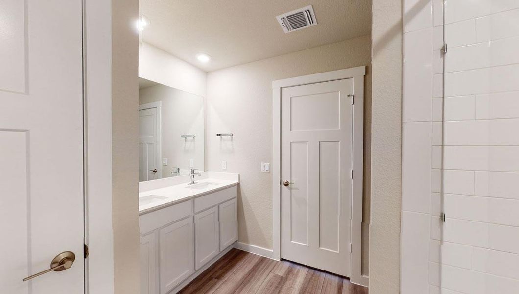 Bathroom featuring light wood-style floors and double vanity