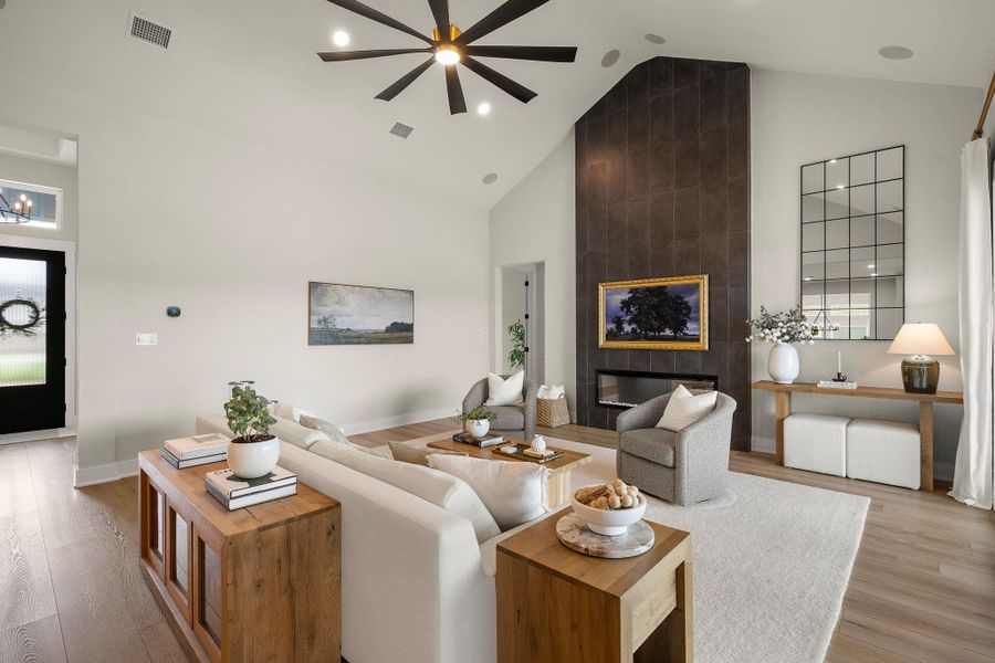 Spacious living room with vaulted ceilings and dramatic fireplace feature.