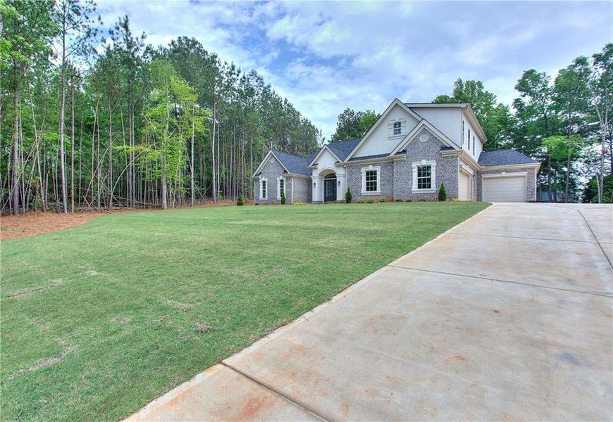 Front exterior of a new home in , Conyers, GA, highlighting curb appeal (Image 30). Front exterior of a new home in , Conyers, GA, highlighting curb appeal (Image 30).
