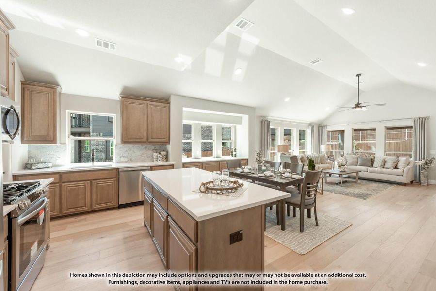 Open-concept kitchen with wood cabinets, center island, and vaulted ceiling flowing into dining and living areas Open-concept kitchen with wood cabinets, center island, and vaulted ceiling flowing into dining and living areas