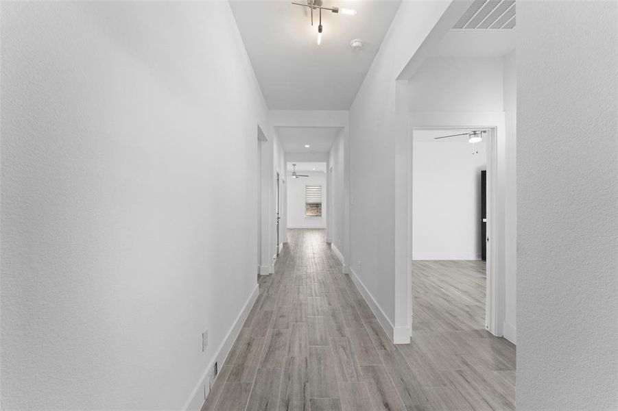 Hallway with light hardwood / wood-style flooring