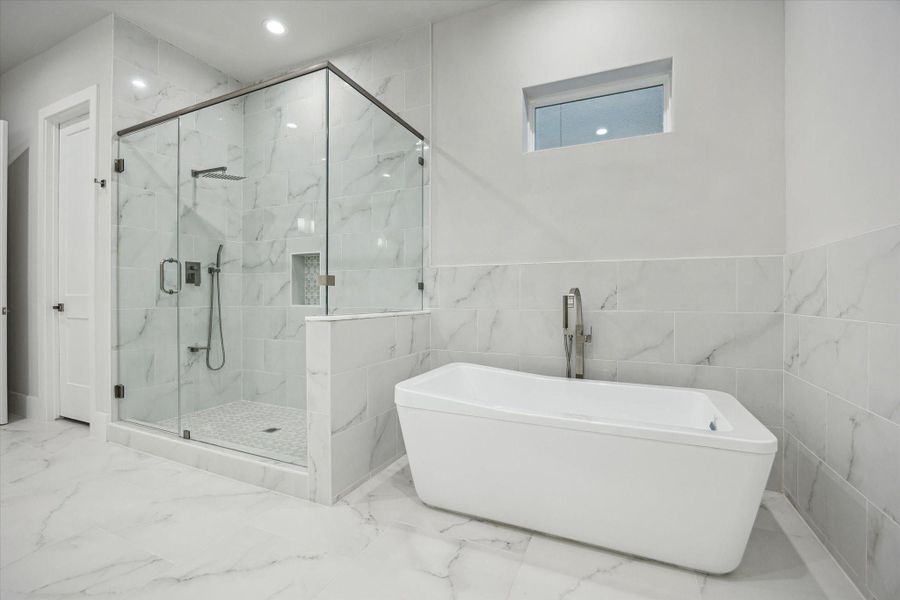 Primary bath - has a an enclosed glass walk-in shower and a soaking tub. Primary bath - has a an enclosed glass walk-in shower and a soaking tub.