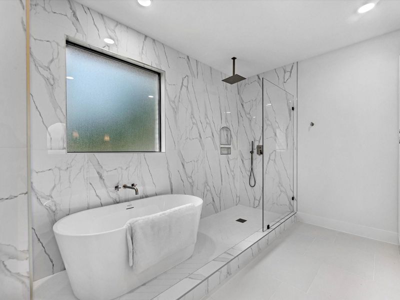Enjoy this soaking tub and rainfall shower!