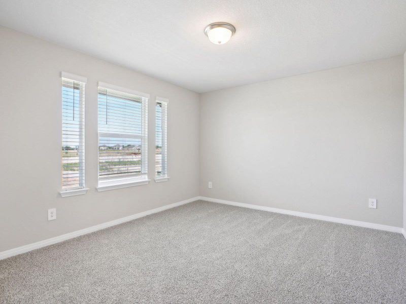 Spare room featuring carpet flooring and baseboards Spare room featuring carpet flooring and baseboards