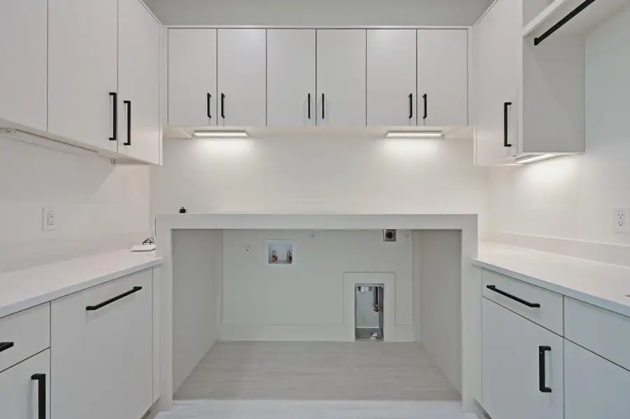 Washroom featuring hookup for a washing machine, cabinet space, hookup for an electric dryer, and gas dryer hookup