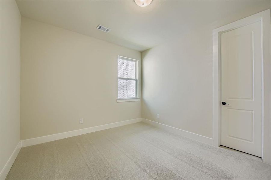 Empty room with light colored carpet Empty room with light colored carpet