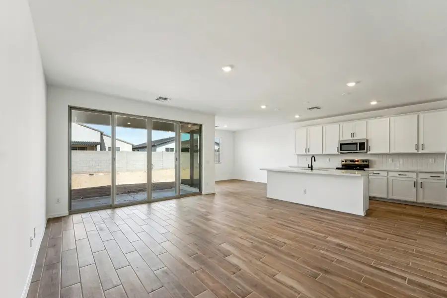 Great room and kitchen. Finishes vary by community