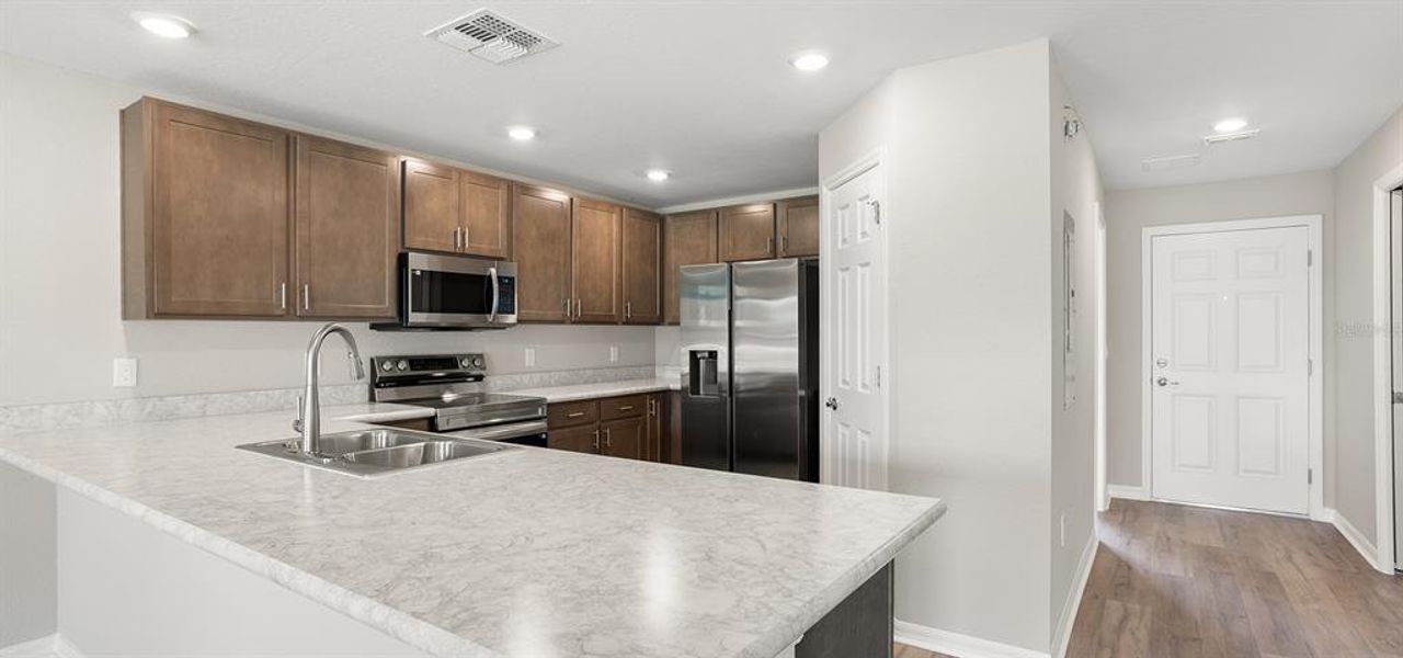 Furnished interior view inside a new home in Harbor at Lake Henry - Townhomes, Winter Haven (Image 6).