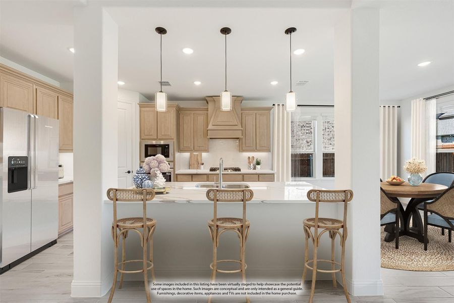 Kitchen with light wood cabinets, white island with three bar stools, pendant lights, and stainless steel refrigerator Kitchen with light wood cabinets, white island with three bar stools, pendant lights, and stainless steel refrigerator