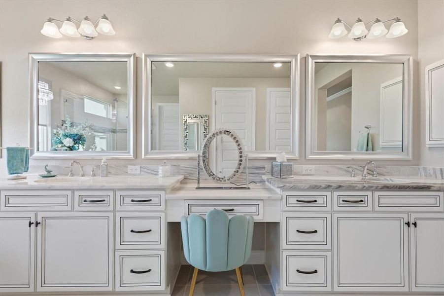 Dual vanity with white cabinetry, framed mirrors, and chrome hardware