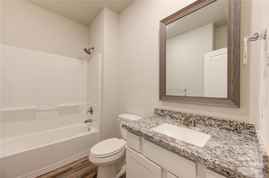 Bath 2 includes granite counters, framed mirror, ceramic tile tub/shower walls & shelving for your linens.