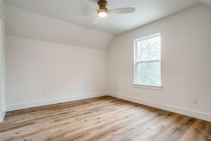 Bonus room featuring ceiling fan, lofted ceiling, and light hardwood / wood-style flooring