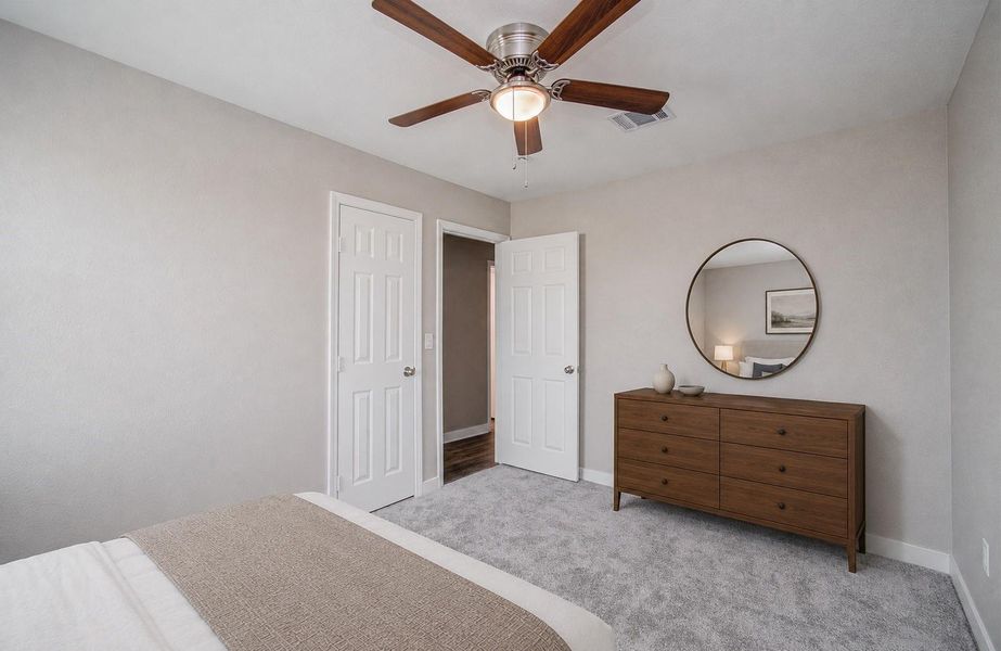 Bedroom 2 view to hallway. Updated carpet, light fixtures and private closet. (Virtually Staged)