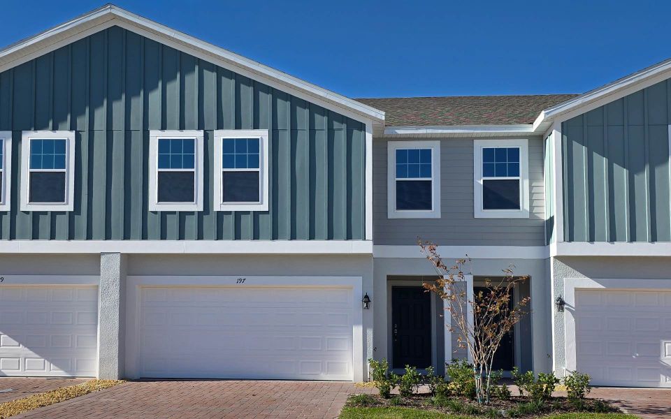 Front exterior of a new home in Blue Springs Reserve Townhomes, Groveland, FL, highlighting curb appeal (Image 11). Front exterior of a new home in Blue Springs Reserve Townhomes, Groveland, FL, highlighting curb appeal (Image 11).